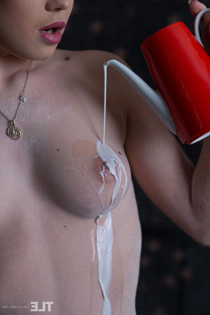 16P Naked model Katia B pours milk over her clear skin before rinsing it off