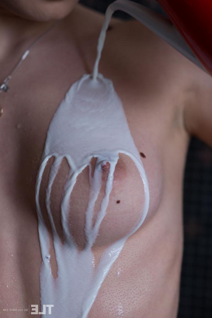 16P Naked model Katia B pours milk over her clear skin before rinsing it off
