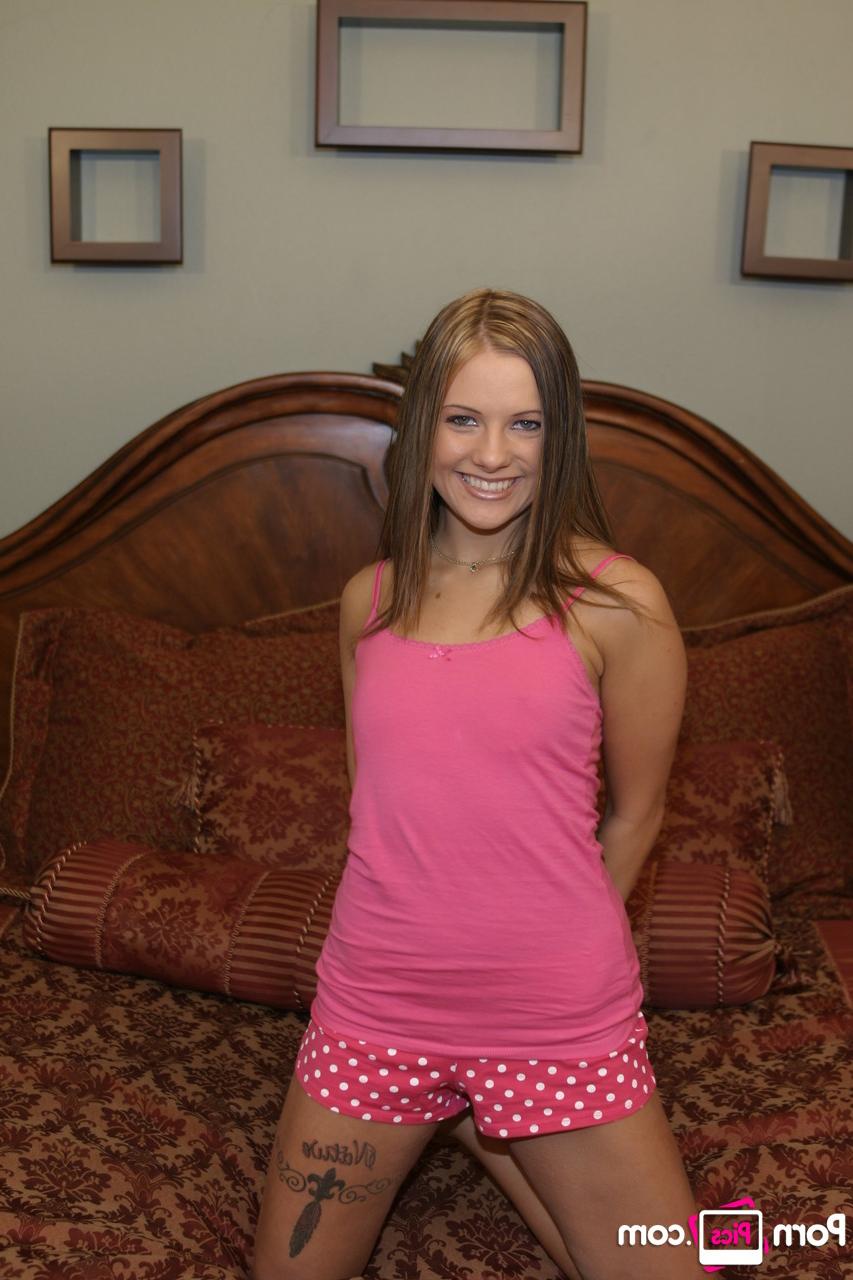 16P Petite babe Autumn Skye shows off her tiny tits & her bald cunt on the bed