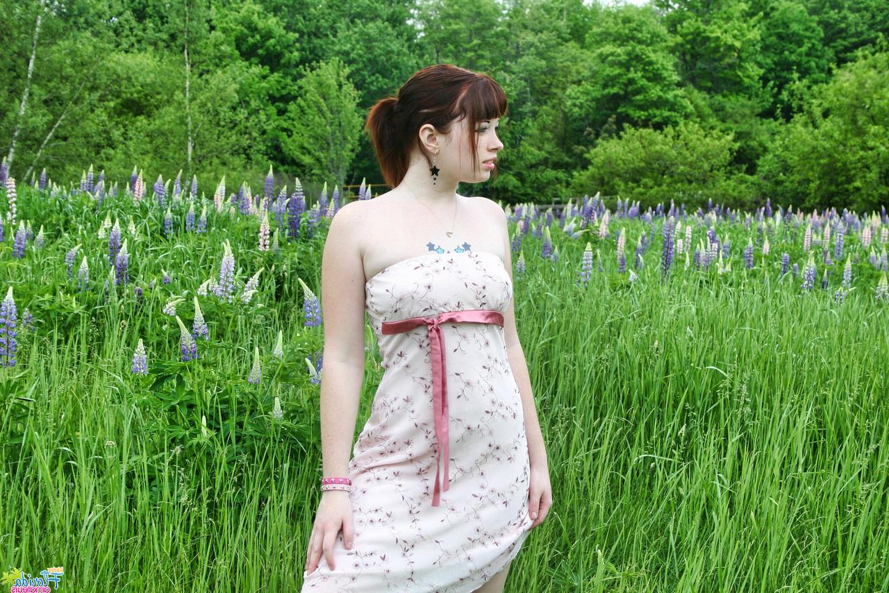 12P Amateur model Barbie A lifts up her dress while in an overgrown field