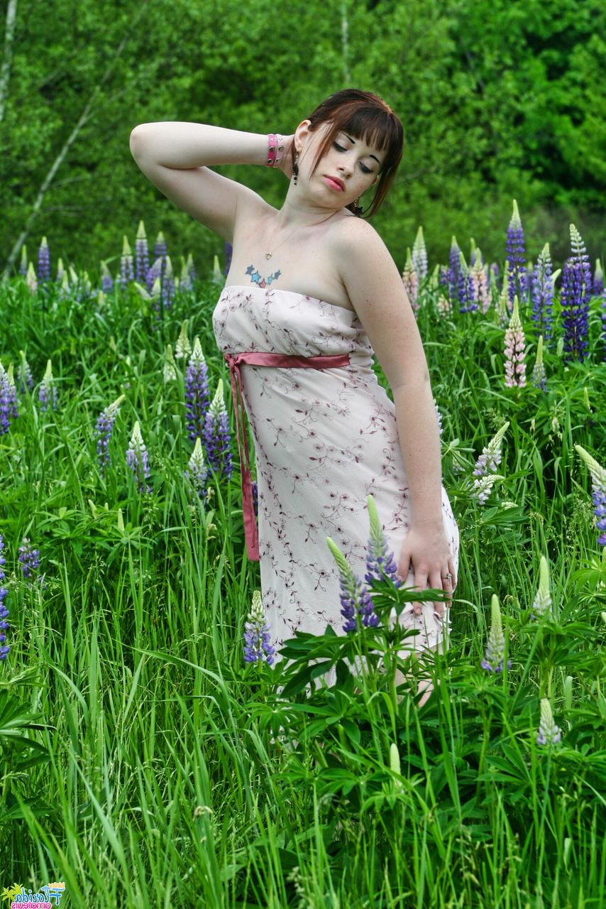 12P Amateur model Barbie A lifts up her dress while in an overgrown field