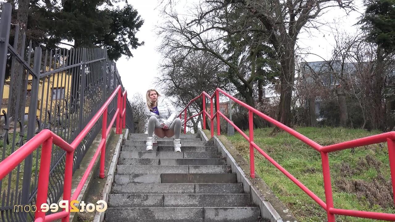 15P Caucasian girl Claudia Macc takes a piss on a flight of concrete steps