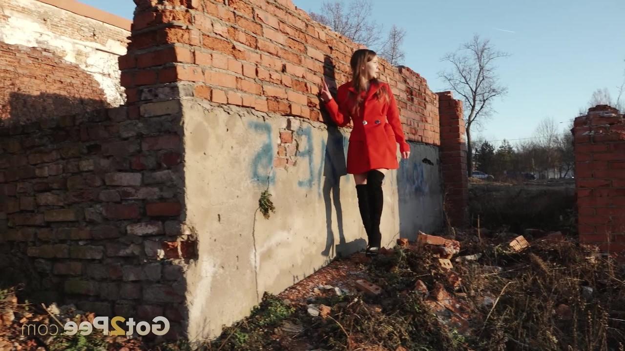15P Caucasian girl Nastya takes a piss behind the remnants of a brick house