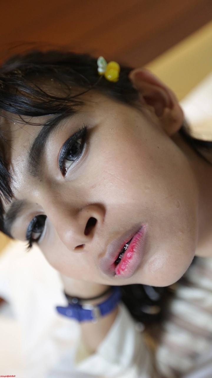 20P Pretty Asian shemale unveils her tiny tits in a sexy striptease on her bed
