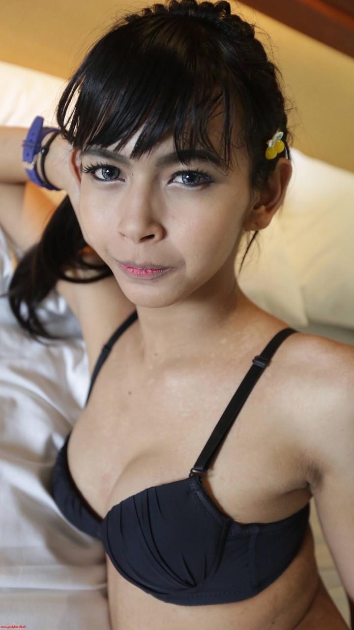 20P Pretty Asian shemale unveils her tiny tits in a sexy striptease on her bed