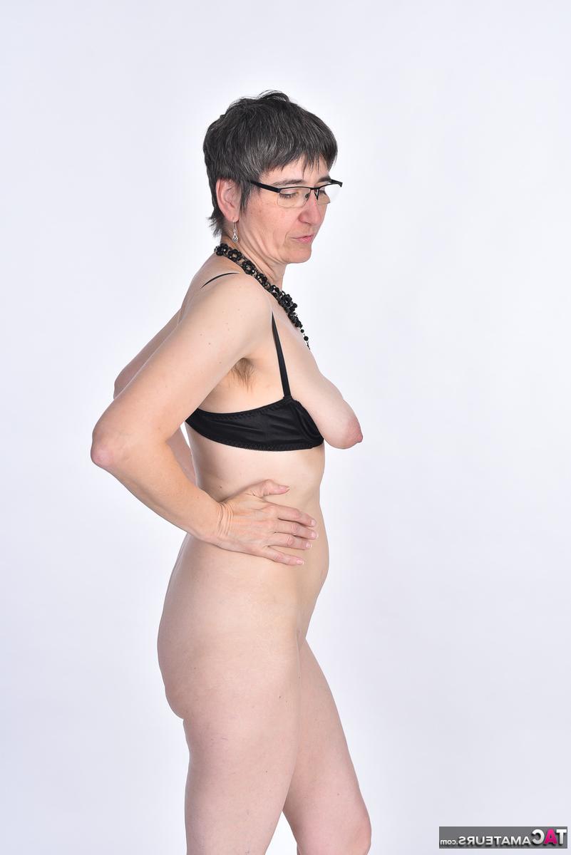 16P Amateur brunette Hot MILF removes a bra and thong set to get naked in glasses