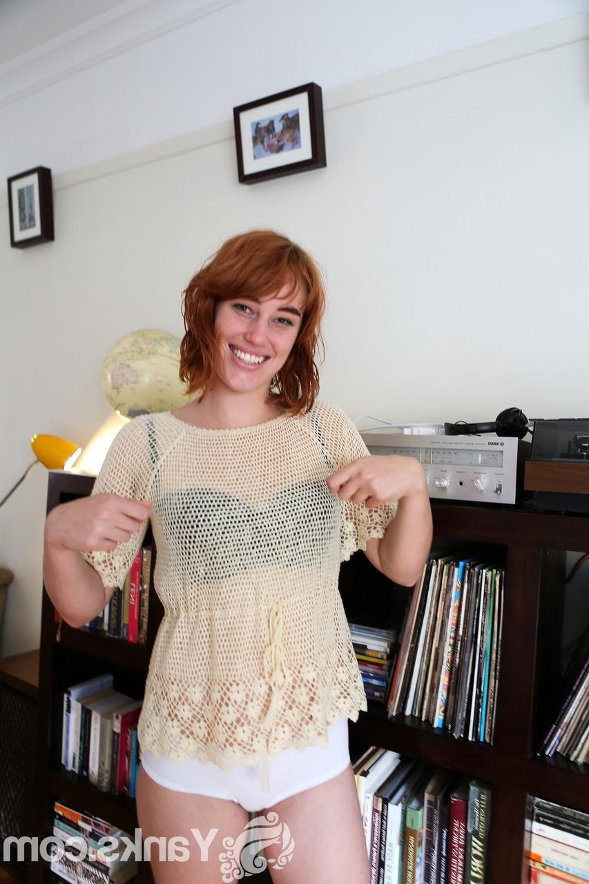 17P Pale redhead Molly Broad strips by the bookcase to flaunt her hairy muff
