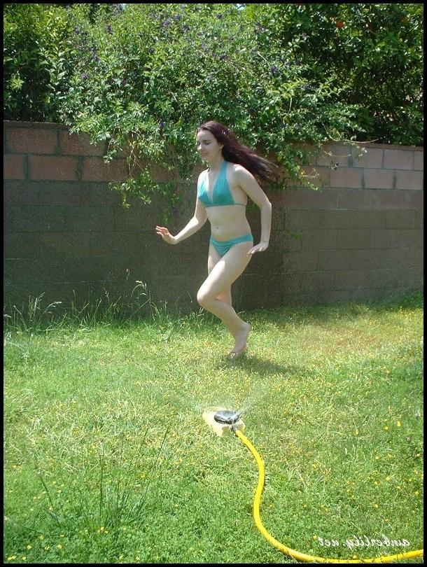 15P Pale chick Amber Lily exposes her ass while wetting herself with a garden hose