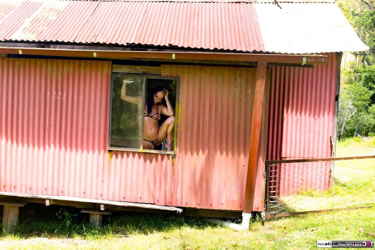 16P Brunette MILF Roxeanne models a revealing bikini in a shack