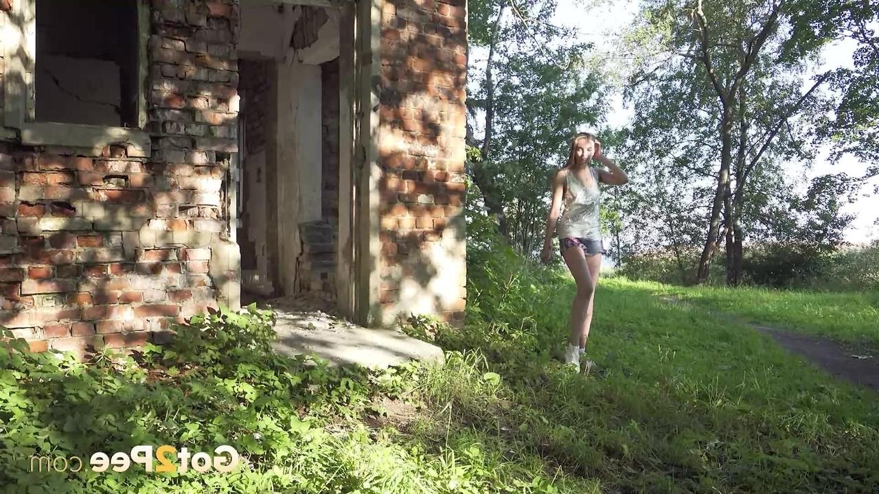 15P Caucasian girl Vika takes a pee in the doorway of an abandoned building