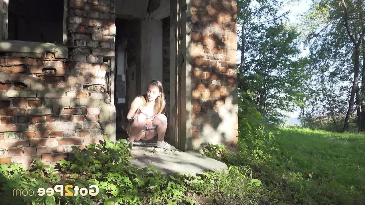 15P Caucasian girl Vika takes a pee in the doorway of an abandoned building