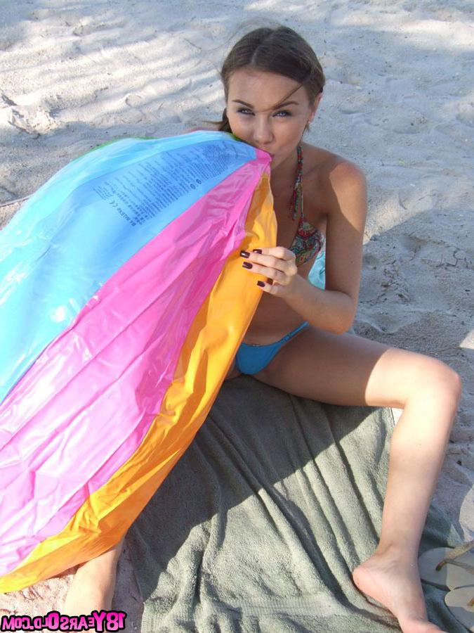 17P Pigtailed teenage darling posing on the beach with so much pleasure