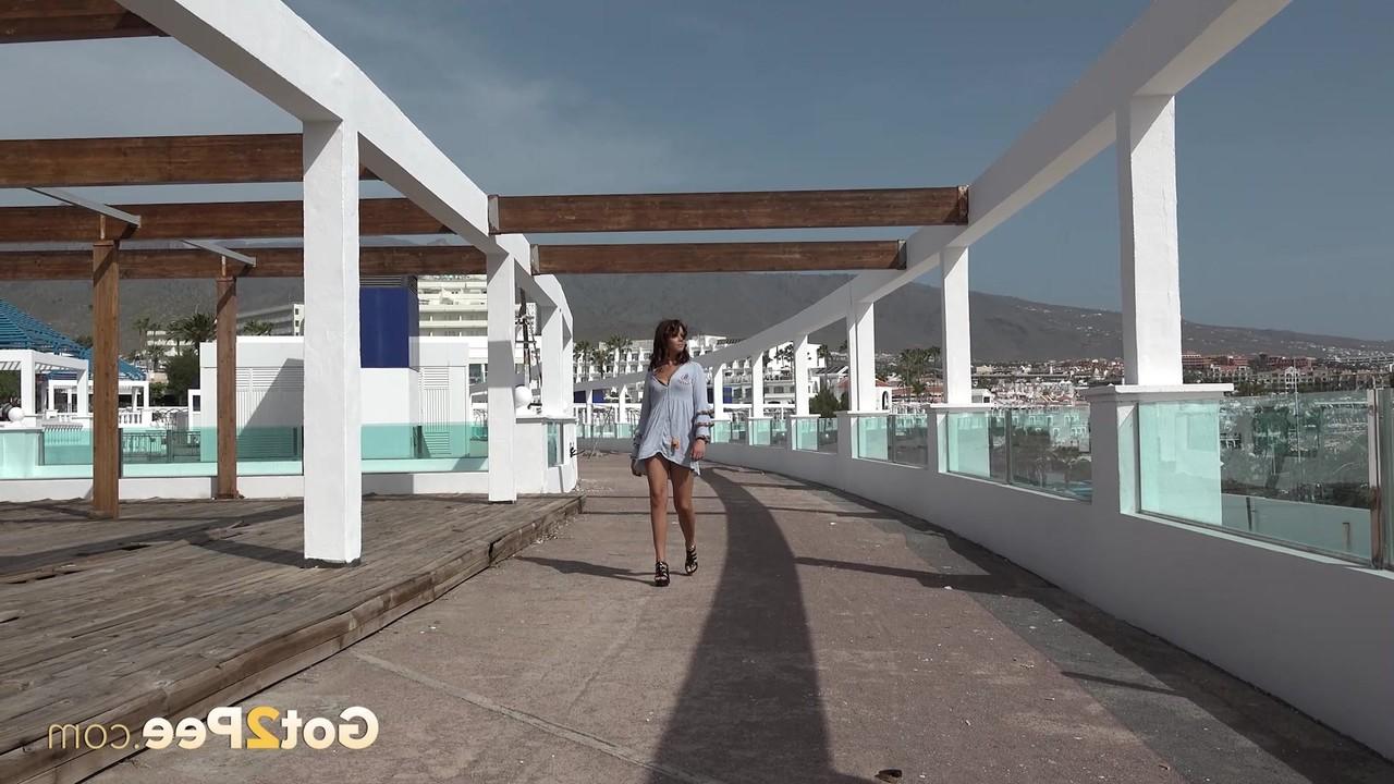15P Caucasian girl Sexy Lexy sits on a curb while pissing on a roadway
