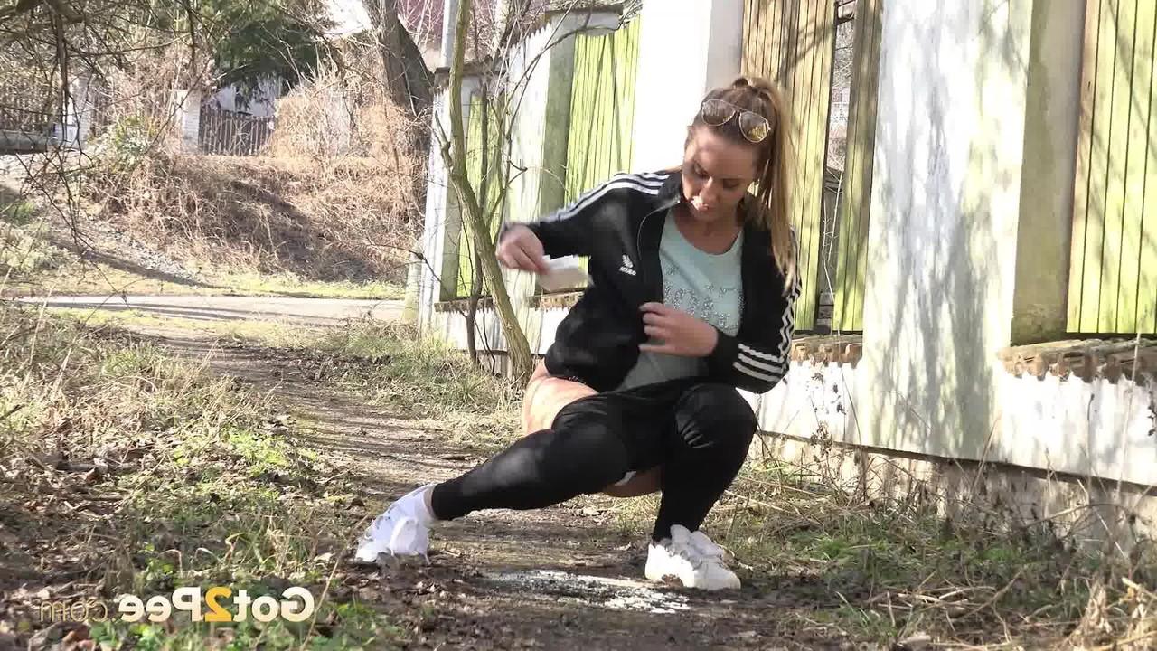15P Naomi Bennet squats for a badly needed pee on a path behind a building
