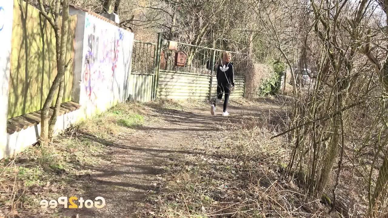 15P Naomi Bennet squats for a badly needed pee on a path behind a building