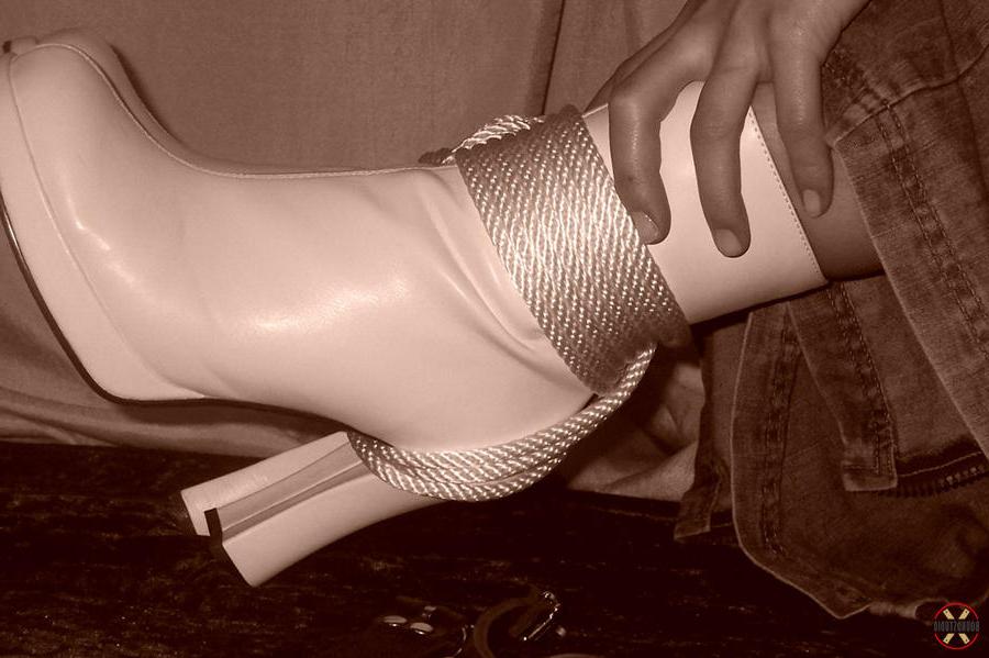 16P Solo model is tied up with rope while fully clothed in white boots