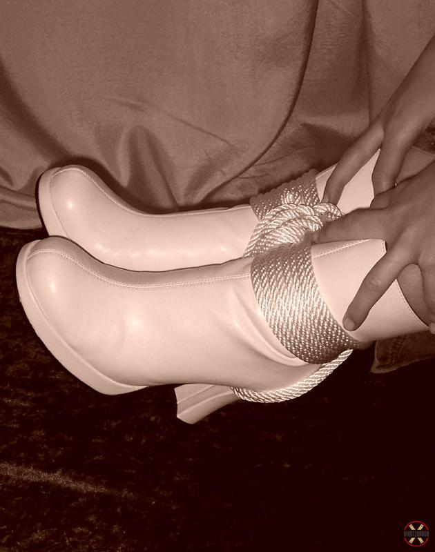 16P Solo model is tied up with rope while fully clothed in white boots
