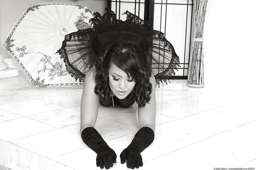 16P Tattooed Asian solo babe Jandi modeling topless for retro style photos