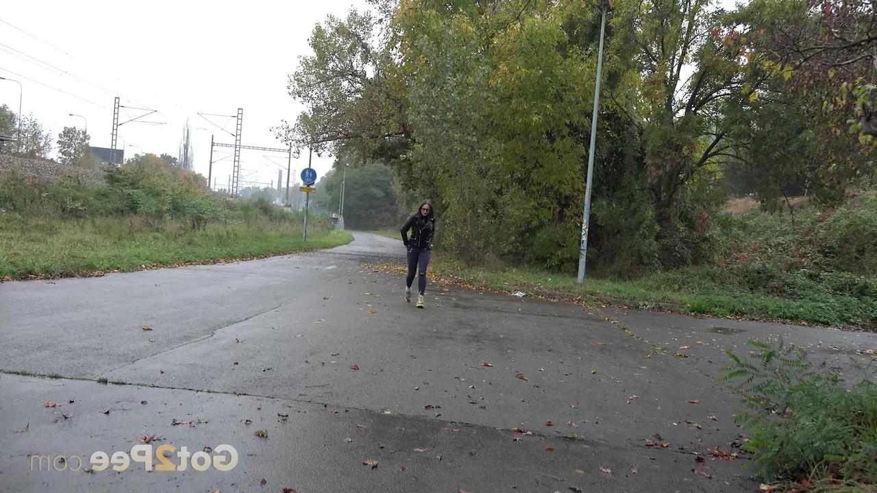 15P Caucasian girl Barbe takes a badly needed piss on wet pavement