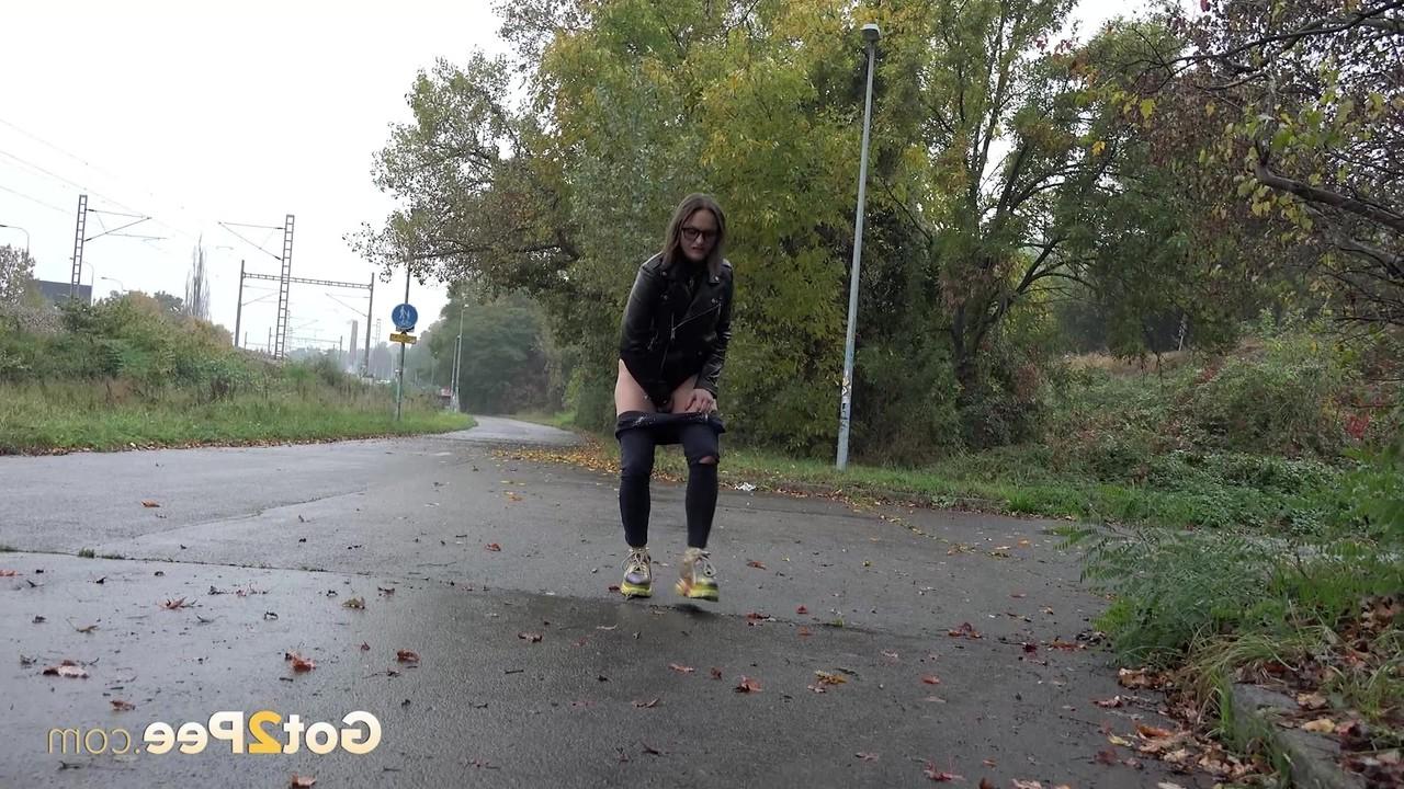 15P Caucasian girl Barbe takes a badly needed piss on wet pavement