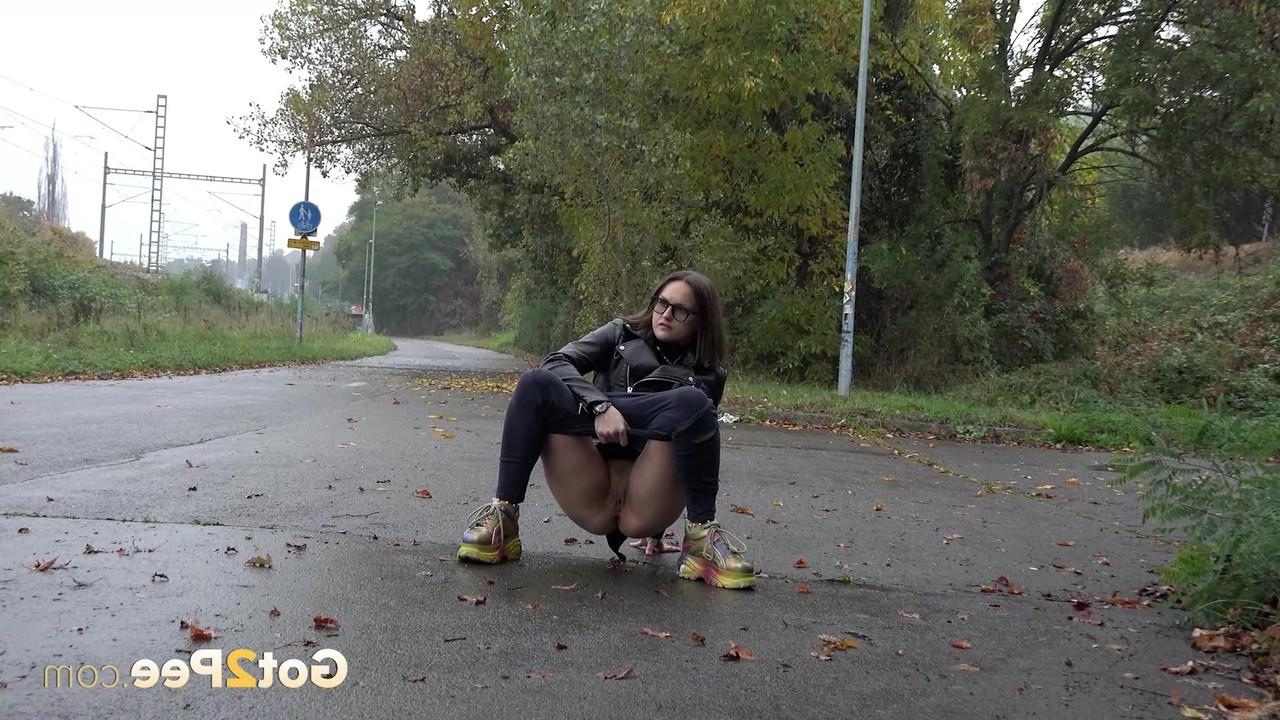 15P Caucasian girl Barbe takes a badly needed piss on wet pavement
