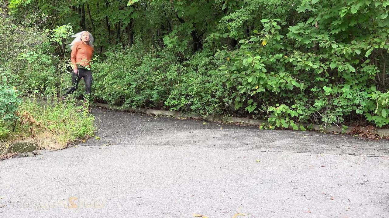 15P Platinum blonde squats for a piss on a paved road in the country