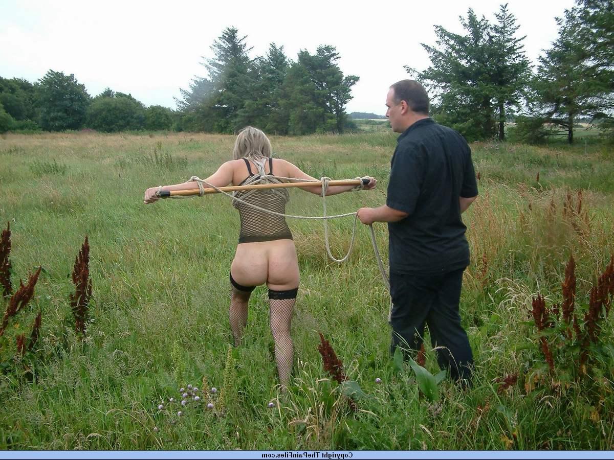 16P Bottomless blonde is affixed to a bar which is attached to an electric fence