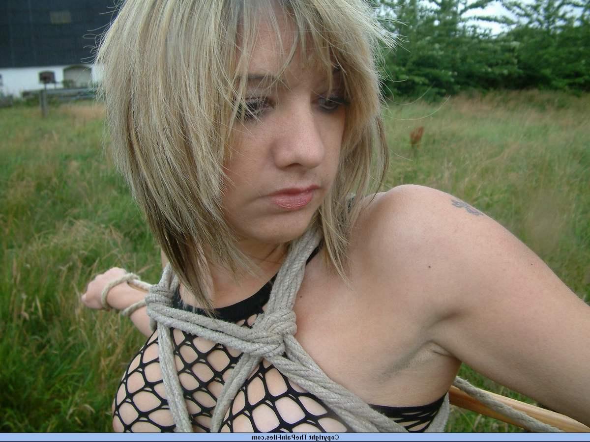 16P Bottomless blonde is affixed to a bar which is attached to an electric fence