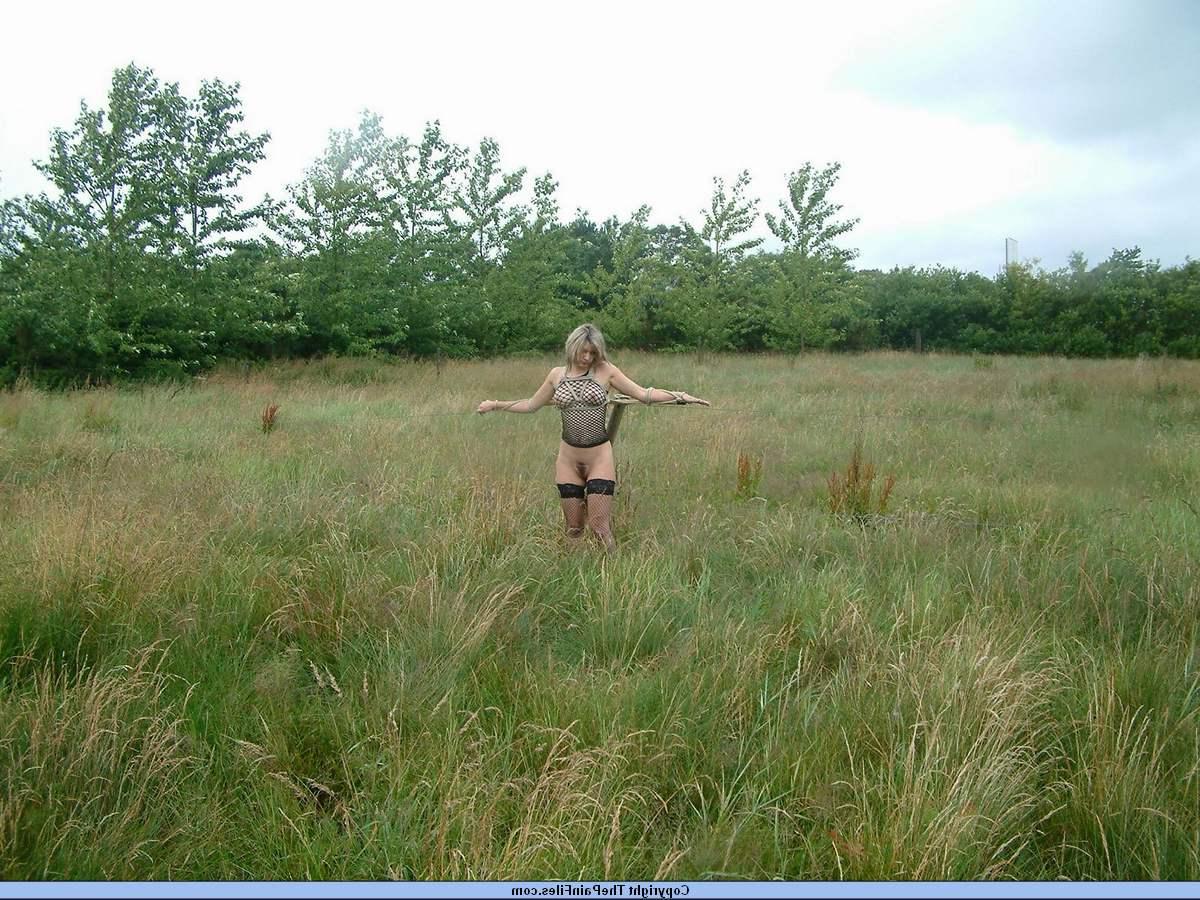 16P Bottomless blonde is affixed to a bar which is attached to an electric fence