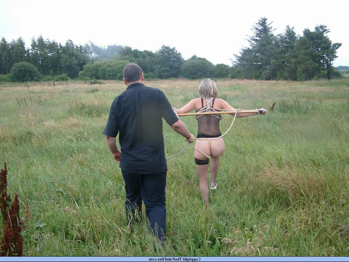 16P Bottomless blonde is affixed to a bar which is attached to an electric fence