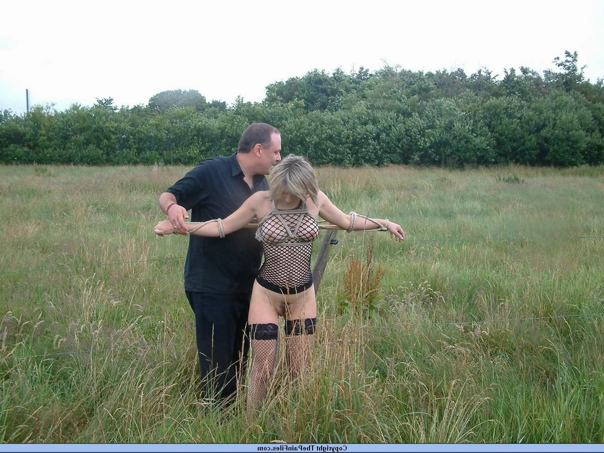 16P Bottomless blonde is affixed to a bar which is attached to an electric fence