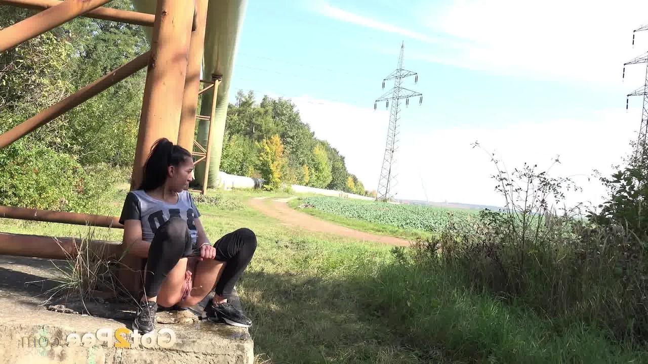 15P Dark haired girl gets caught taking a pee on a security camera