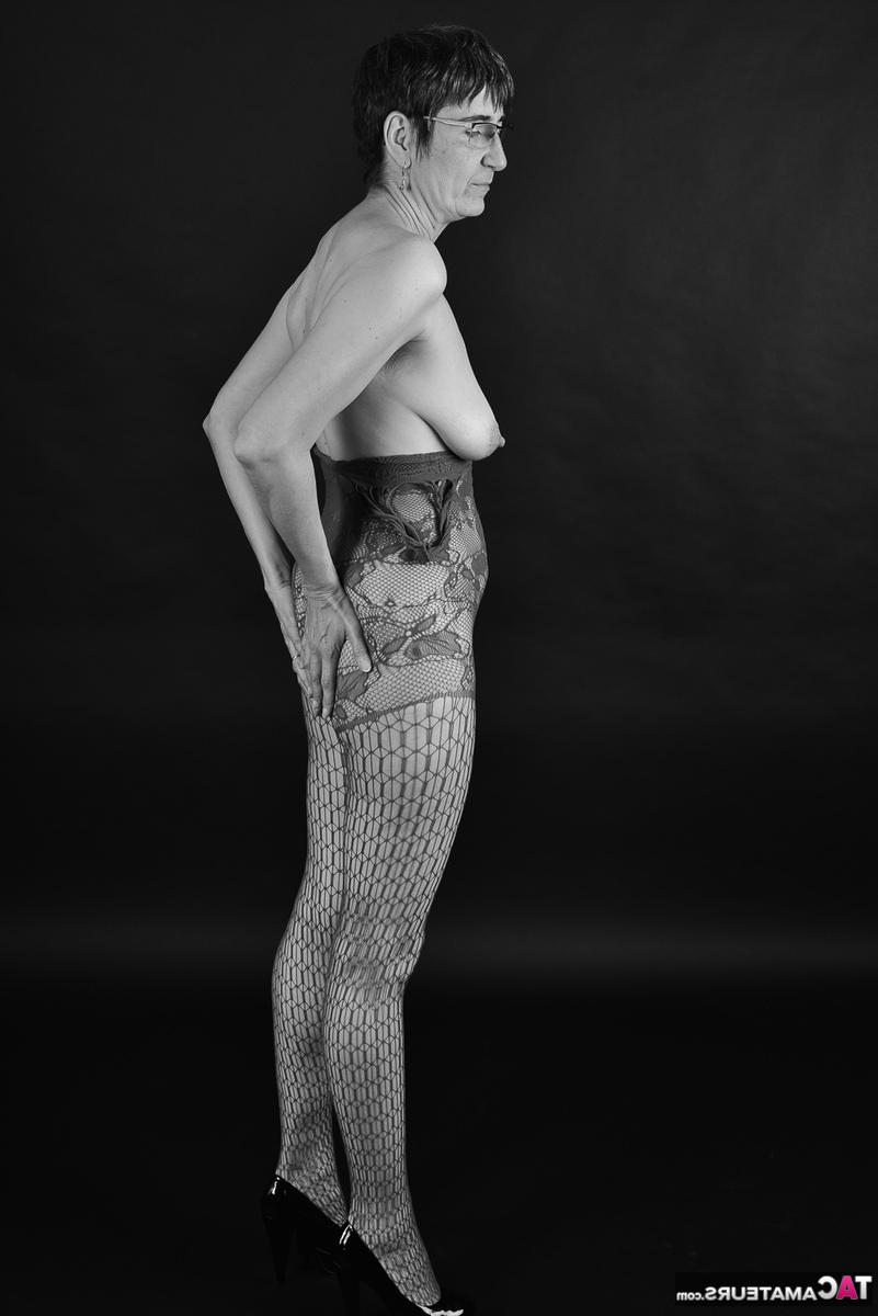 20P Mature amateur with saggy tits releases her bald snatch from a bodystocking