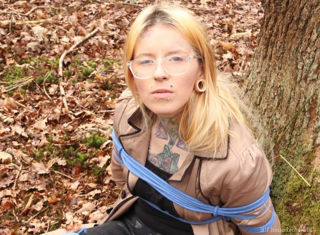 16P Nerdy girl is left gagged and rope bound against a tree in the forest