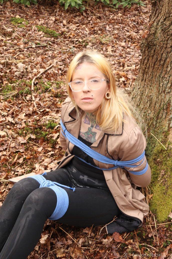 16P Nerdy girl is left gagged and rope bound against a tree in the forest