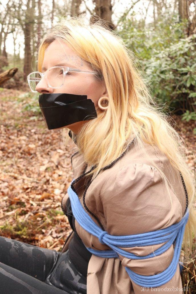 16P Nerdy girl is left gagged and rope bound against a tree in the forest