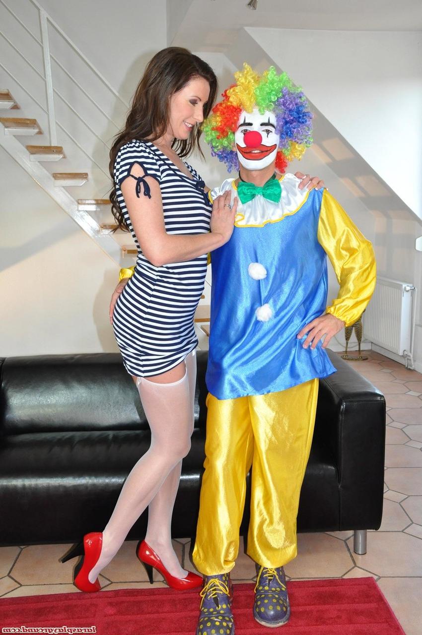 20P Tall MILF Lara strips for a clown before taking his knob deep on the floor