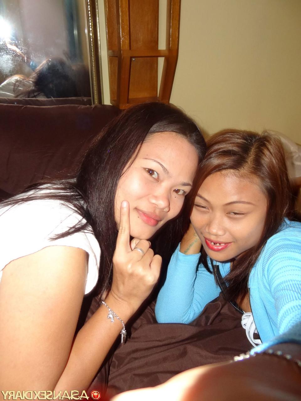 15P Asian girls Irish and Leann get completely naked atop a bed