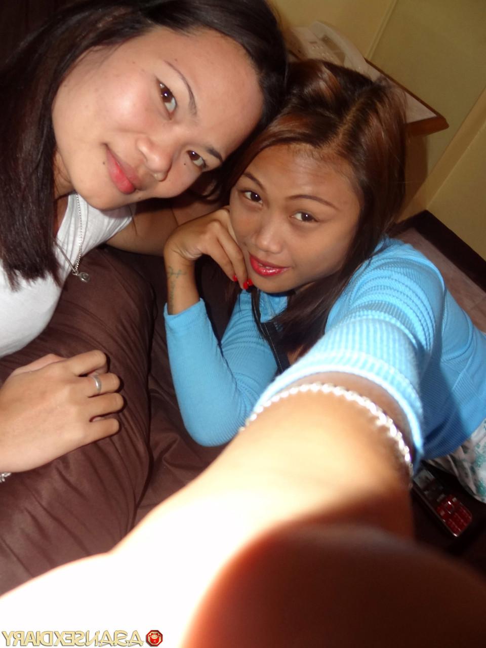 15P Asian girls Irish and Leann get completely naked atop a bed