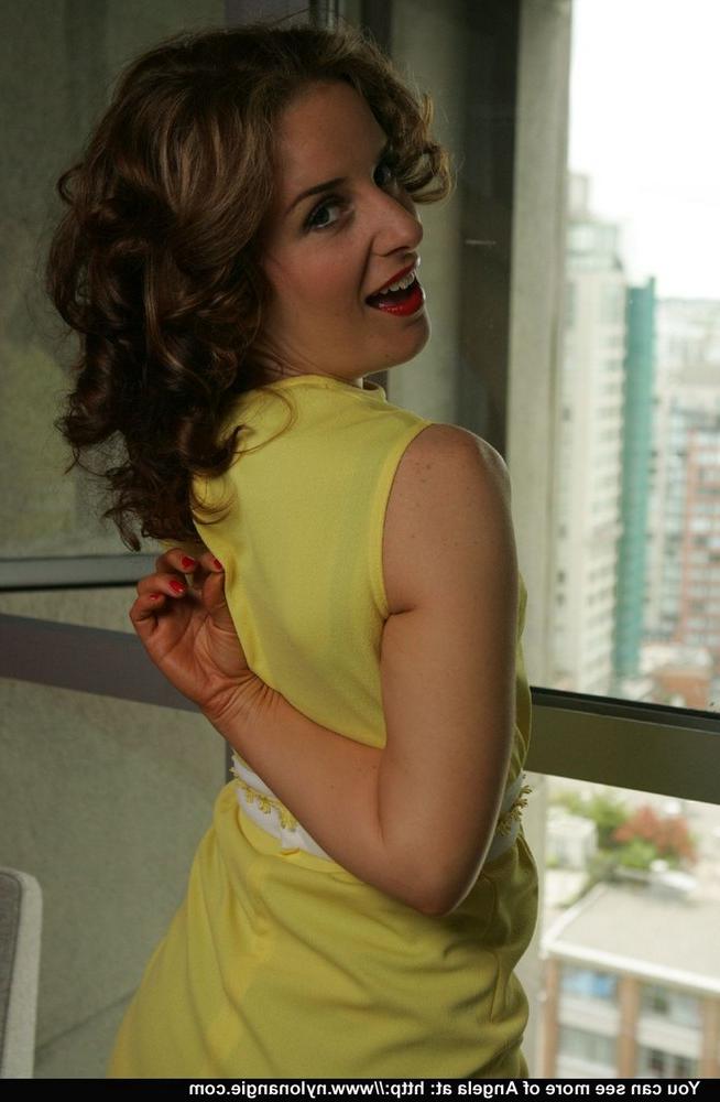 12P Mature woman Dirty Angie strips to 3 piece lingerie in front of a window