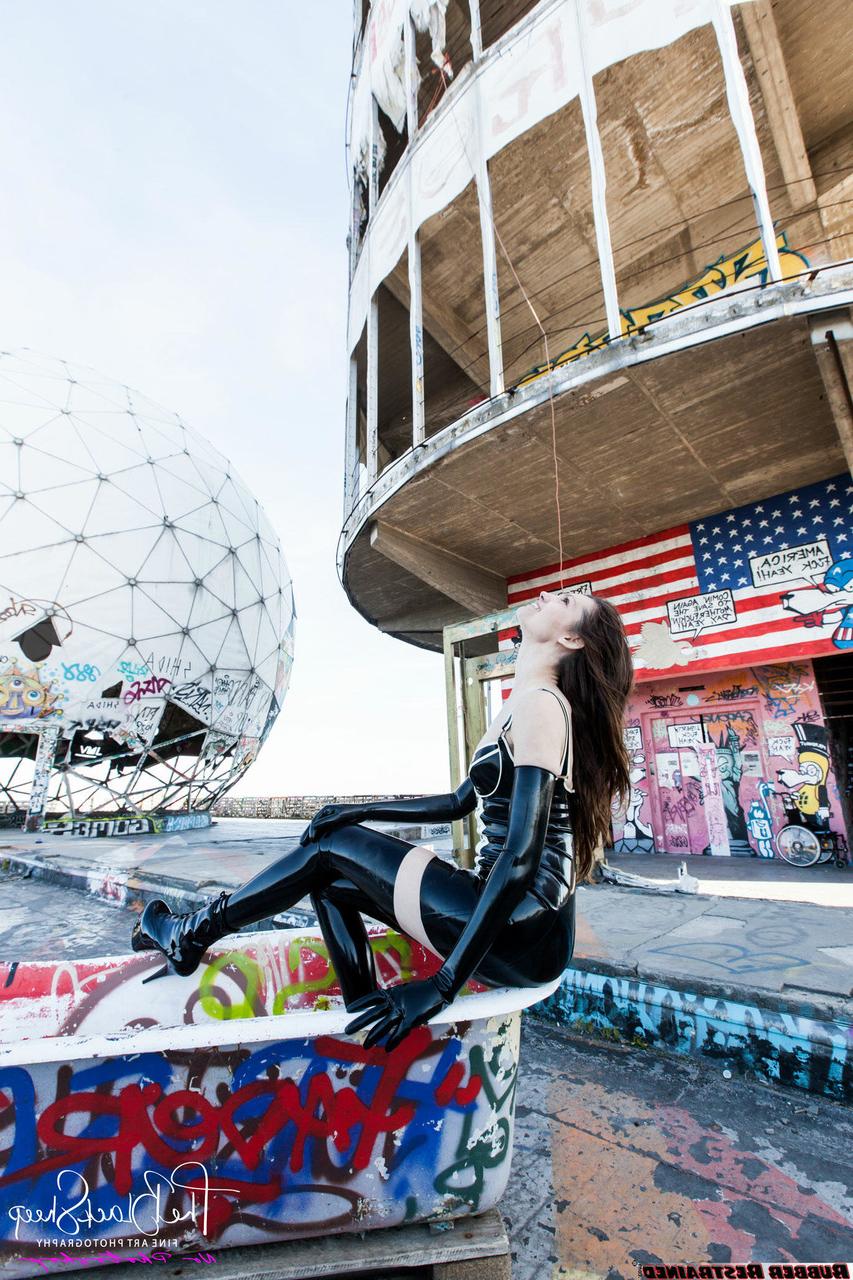 16P Fetish model Ropemarks wears latex clothing at an abandoned amusement park