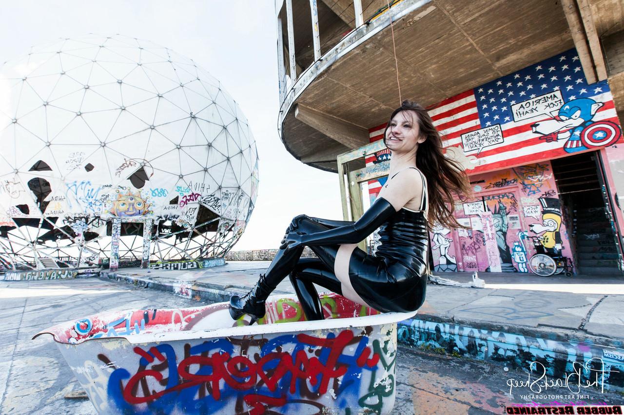 16P Fetish model Ropemarks wears latex clothing at an abandoned amusement park