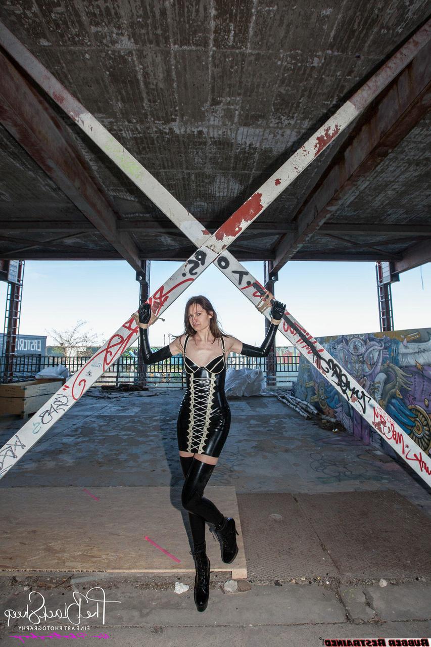 16P Fetish model Ropemarks wears latex clothing at an abandoned amusement park