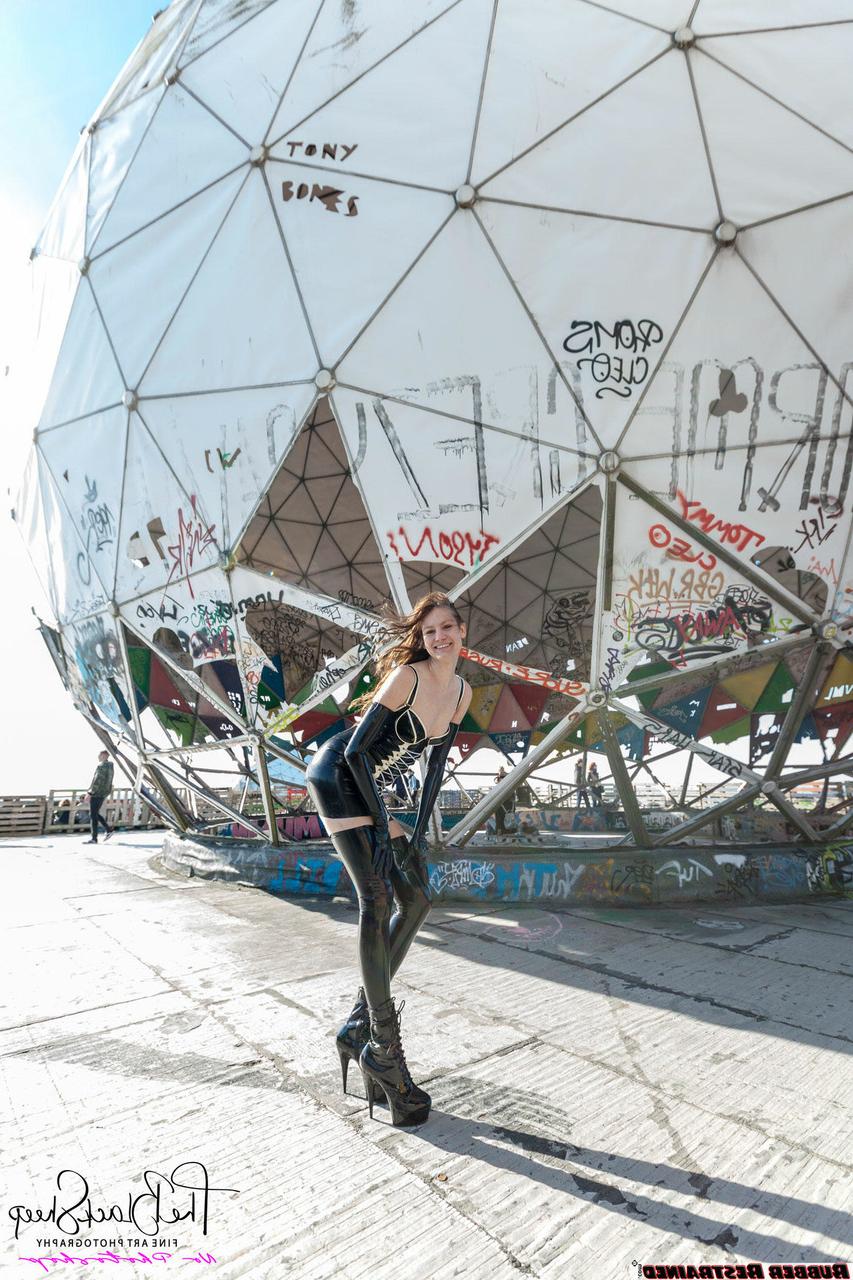 16P Fetish model Ropemarks wears latex clothing at an abandoned amusement park