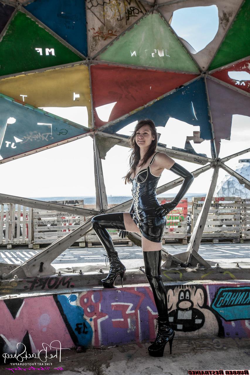 16P Fetish model Ropemarks wears latex clothing at an abandoned amusement park
