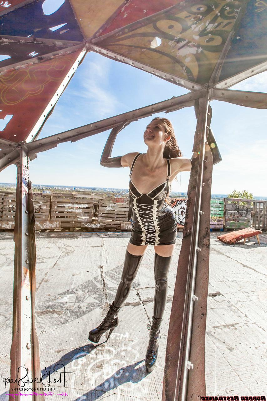 16P Fetish model Ropemarks wears latex clothing at an abandoned amusement park
