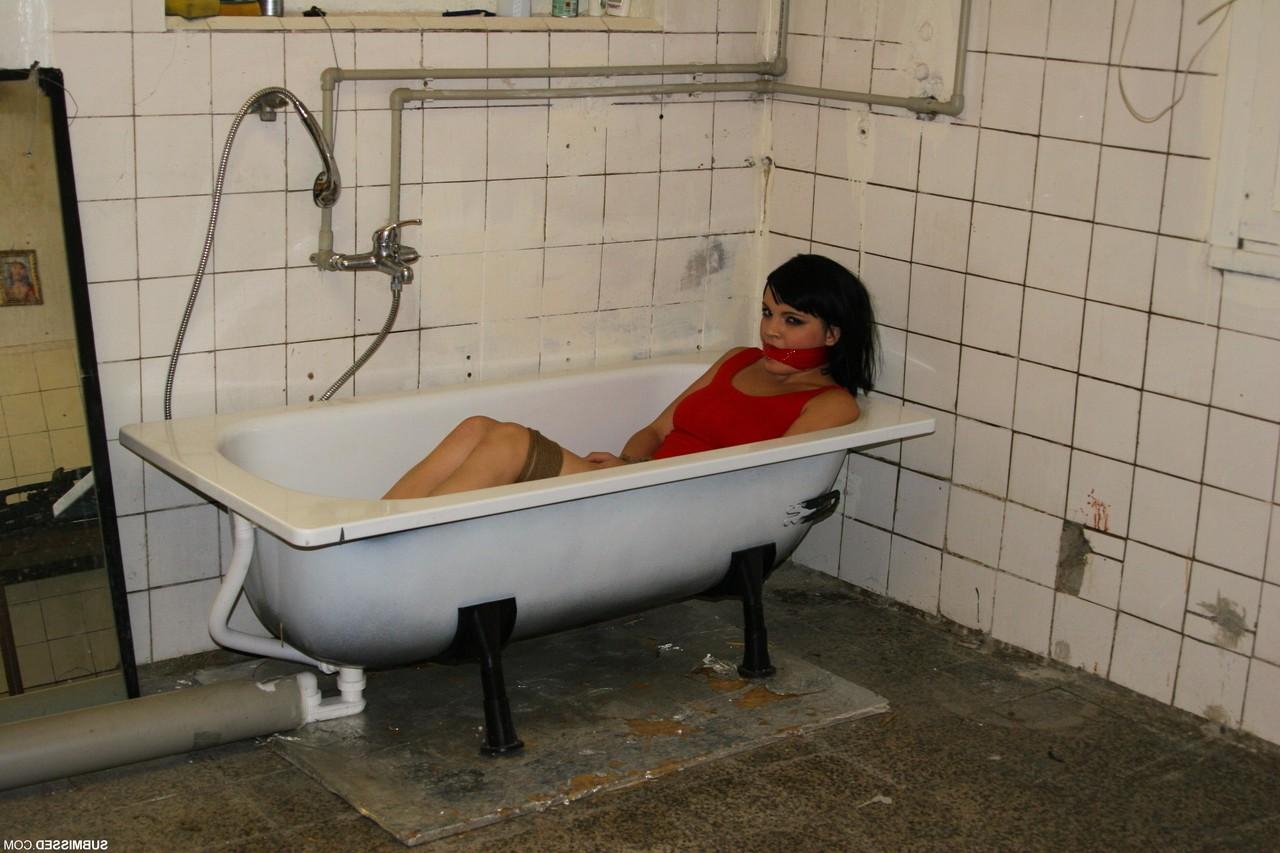 17P Tied up brunette Nicola lies in bathtub while master dominates over her