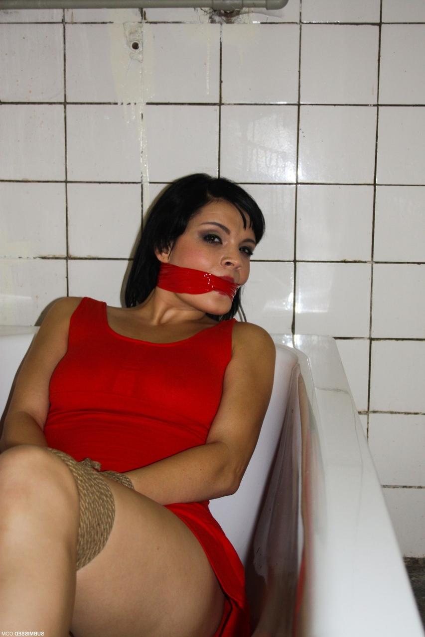 17P Tied up brunette Nicola lies in bathtub while master dominates over her
