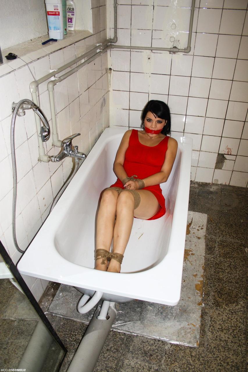 17P Tied up brunette Nicola lies in bathtub while master dominates over her