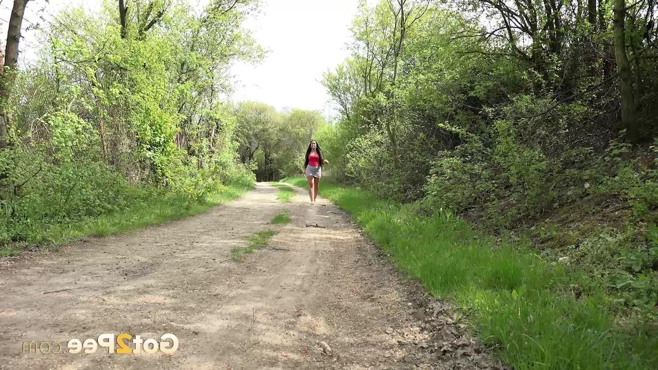 15P Dark-haired girl Lolita Black gets caught taking a piss on a dirt road